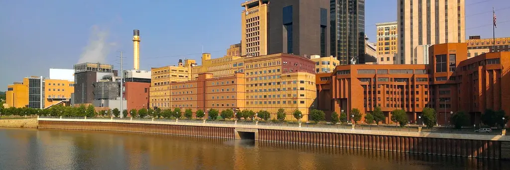 Downtown Saint Paul riverfront buildings reflected in the Mississippi River in warm evening light